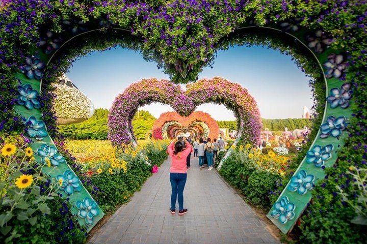Step into a floral wonderland with stunning heart-shaped arches and millions of blossoms providing an unforgettable backdrop for memorable photos and leisurely strolls through nature's masterpiece.